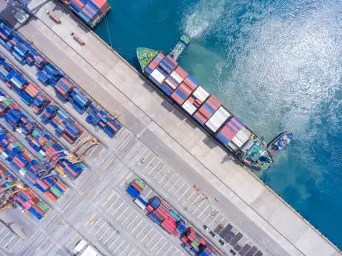 Aerial view of a container ship unloading at a port