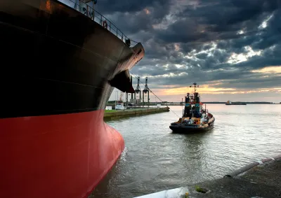 Ship and tugboat departing harbour